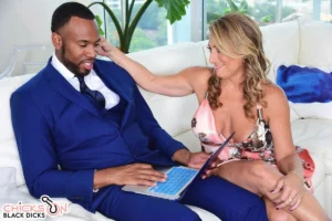 Intimate moment on luxurious white sofa: brunette MILF Torri Lee touches insurance salesman Jovan Jordan's crotch flirtatiously.